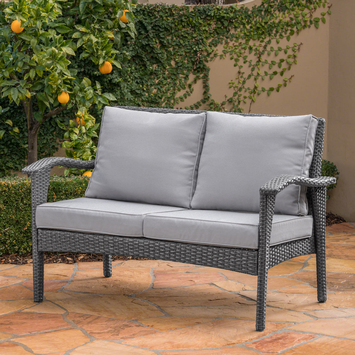 The Contoured All-Weather Wicker Loveseat by Christopher Knight Home
