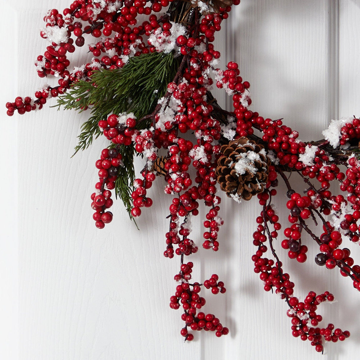 24” Frosted Cypress Artificial Wreath with
Berries and Pine Cones