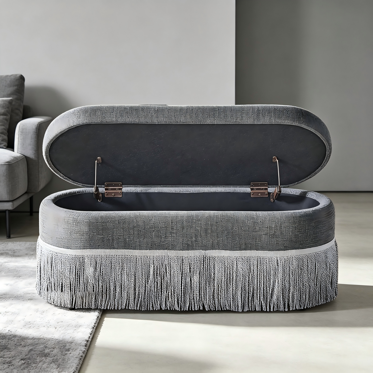 Oval Upholstered Storage Ottoman with Fringe Trim
