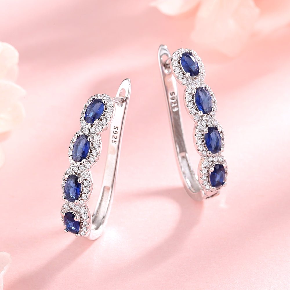 Blue & White Sapphire Halo Huggie Earrings in Sterling Silver - Tuesday Morning-Huggie Earrings