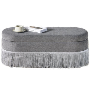 Oval Upholstered Storage Ottoman with Fringe Trim