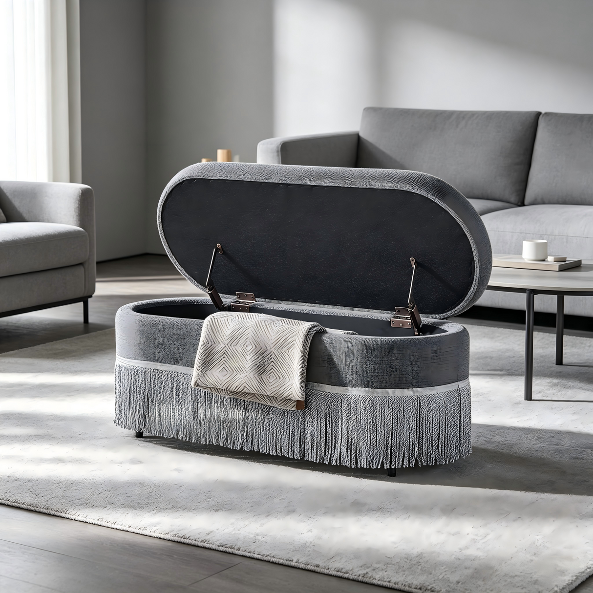 Oval Upholstered Storage Ottoman with Fringe Trim