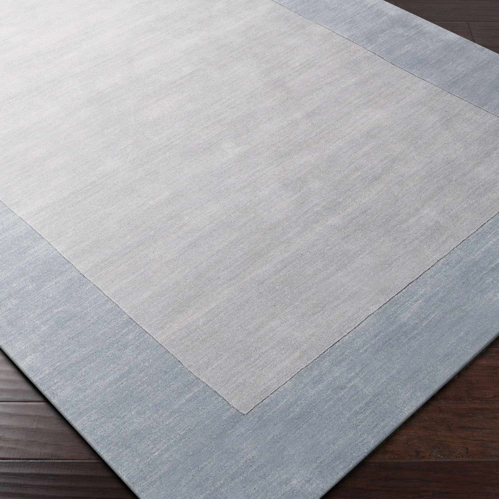 Arkabutla Solid Blue Bordered Wool Rug