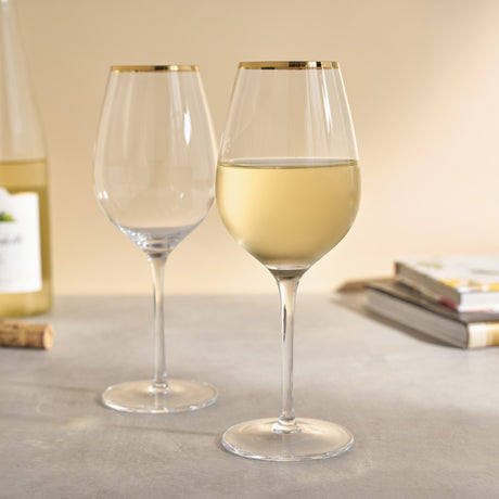 Gilded stemmed wine glass set by twine