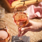 Gilded stemmed wine glass set by twine