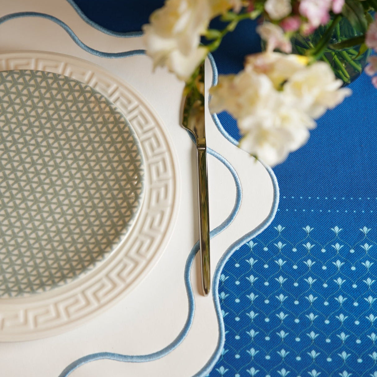 Haven White Wavy Edge Blue Trim Faux Leather Placemats