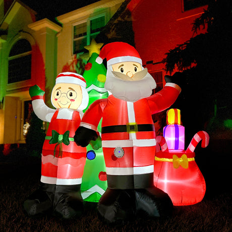 6-Ft. Tall Prelit Mr. and Mrs. Claus with Tree Inflatable with Music