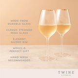 Gilded stemmed wine glass set by twine