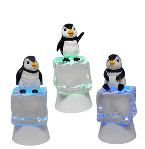 Penguin Sitting on Color-changing Lighted Icecube -