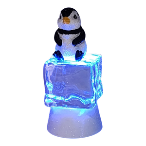 Penguin Sitting on Color-changing Lighted Icecube -